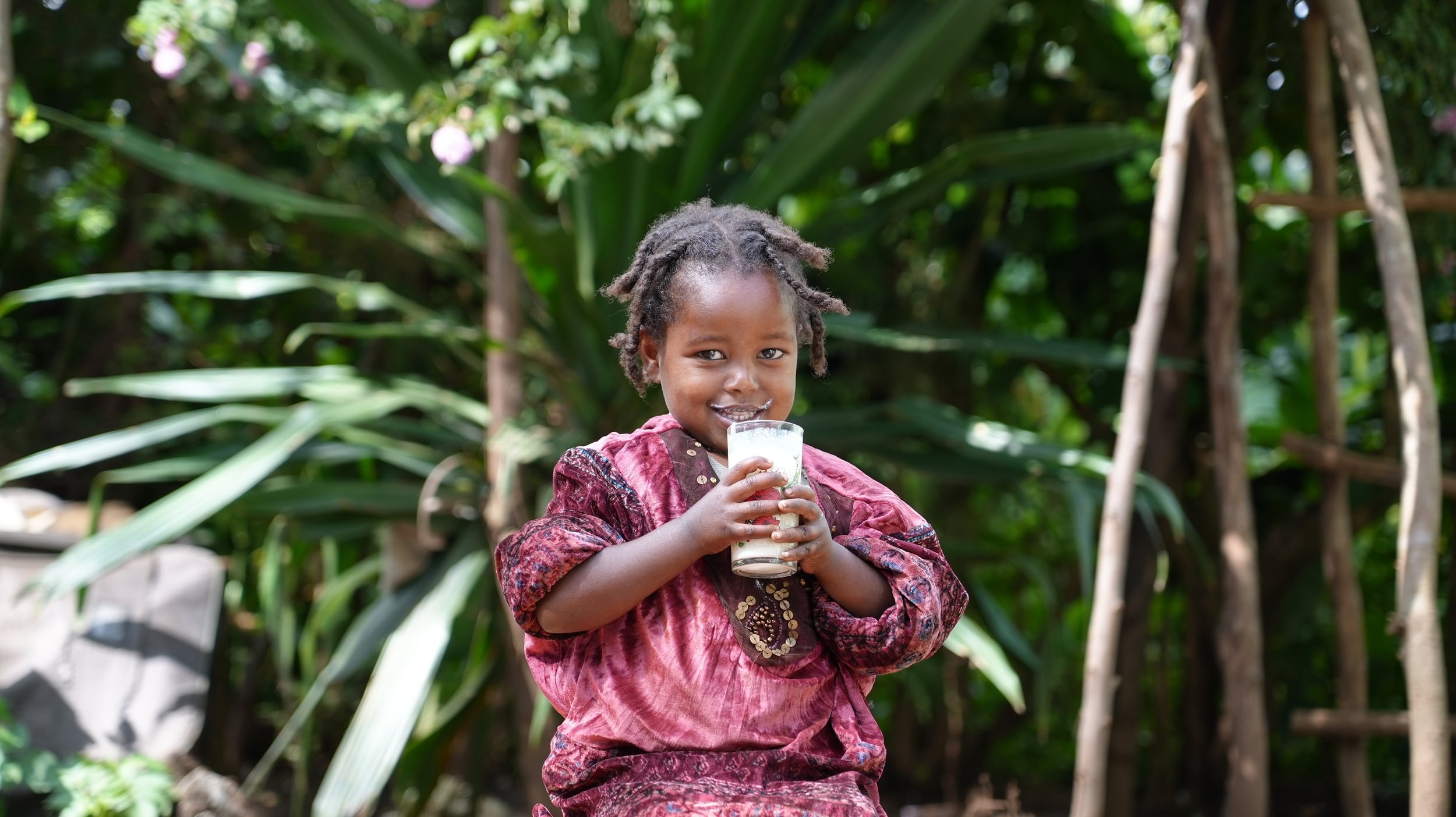 https://d1l97138avwug7.cloudfront.net/Zenebech-supports-her-friend-Meselech-and-her-daughter-Firehiwot-whos-4-drinking-milk-5-Large-1_2026-09-22-090728_ajnb.jpg