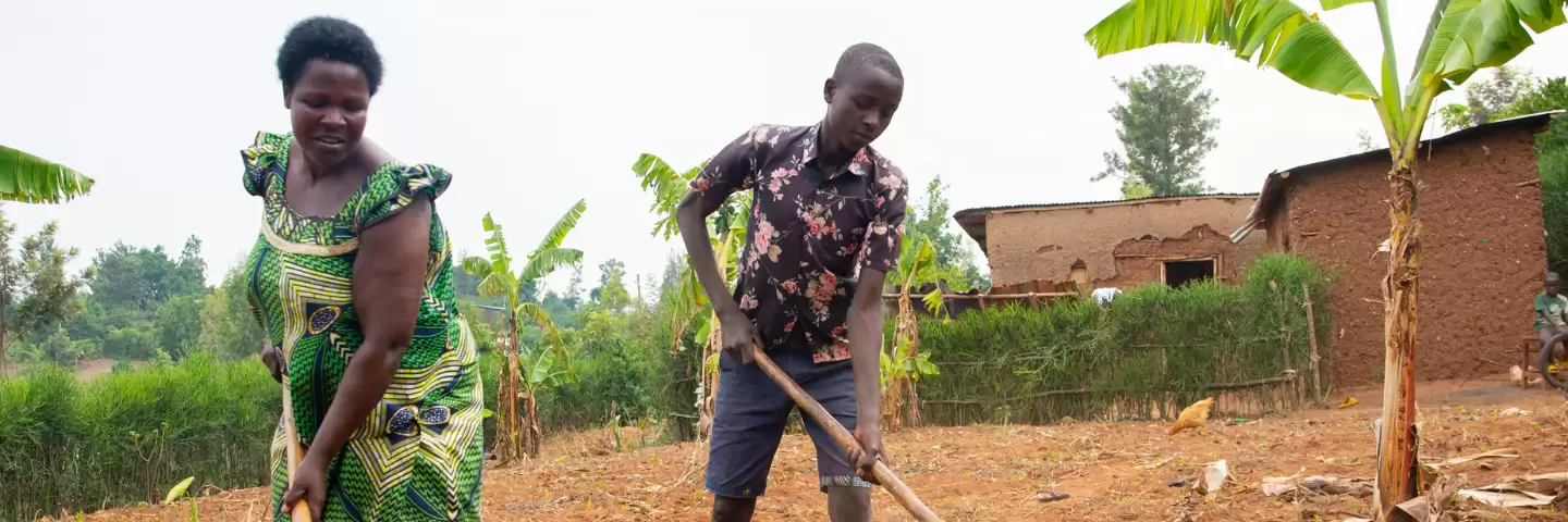 A mother and son digging their land