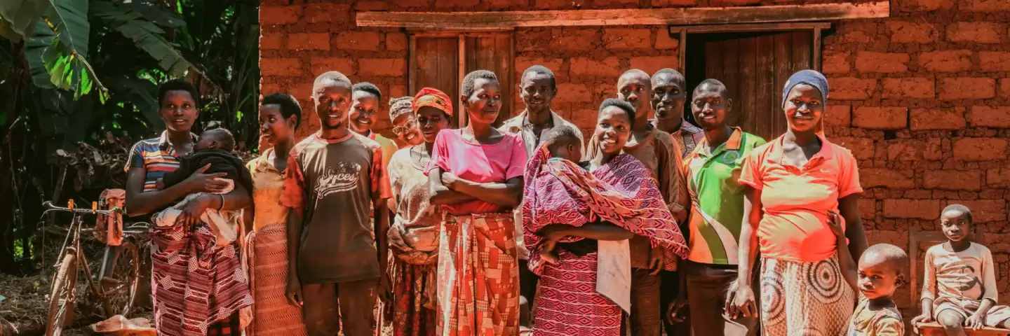 Joselyne and her community in Burundi, smiling for a group photo