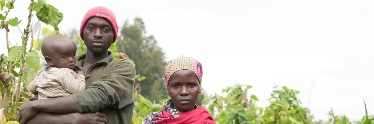 A man and woman holding their young child