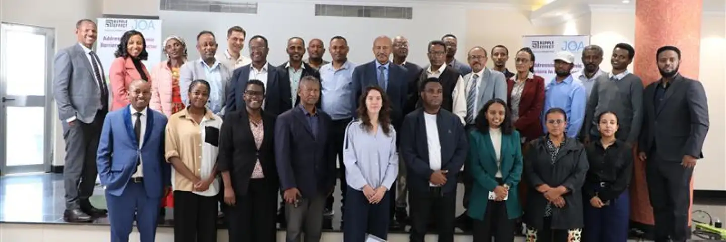 Group photo of workshop participants standing together indoors