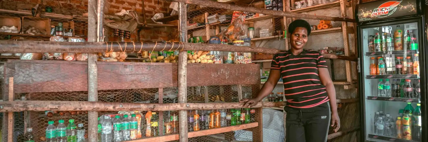 Ugandan woman posing in her confectionary store