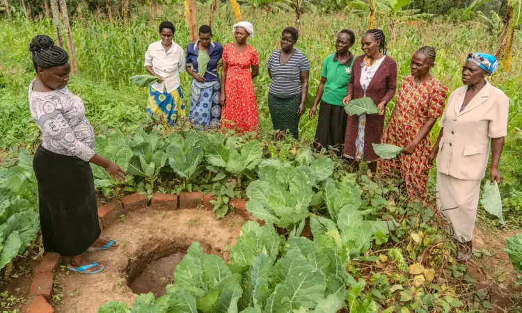 Christine, a peer farmer and project participant in Kenya, is giving farming training to other women in her community