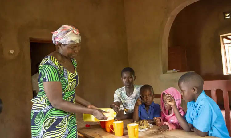Therese, a dairy farmer from Rwanda, serves milk to her children as a source of protein