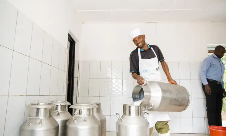 Jean Baptist, a local youth employed by the KOZIMURU cooperative as a milk transporter.