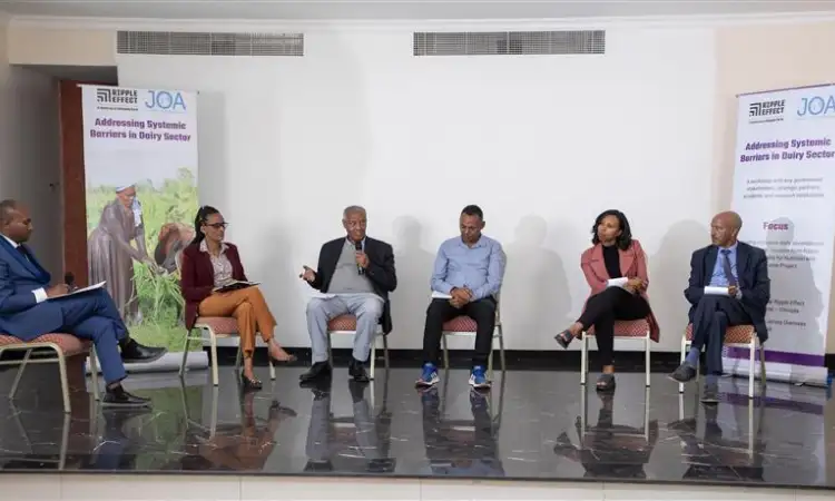 Panel discussion with speakers seated at the front of a workshop room.