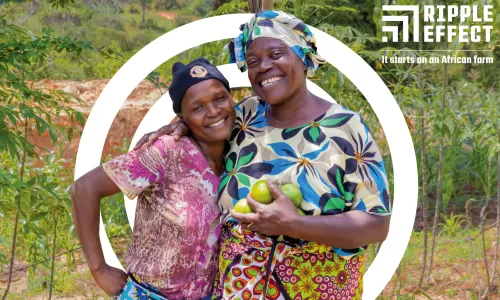 Two Ripple Effect farmers holding fruit