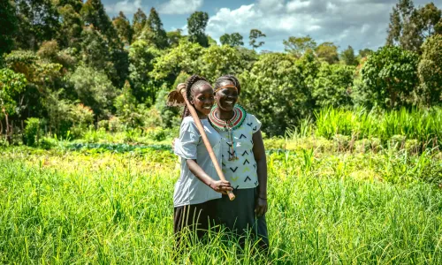 Priscilla and her daughter in their green and thriving field