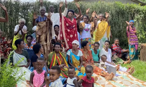 Group of Rwandan women waving at the camera