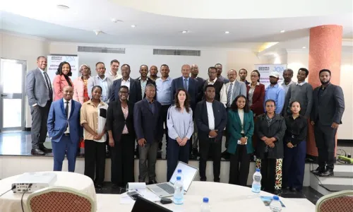 Group photo of workshop participants standing together indoors