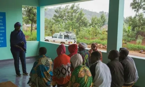 Person speaking to a group of community members during a meeting or training sessio