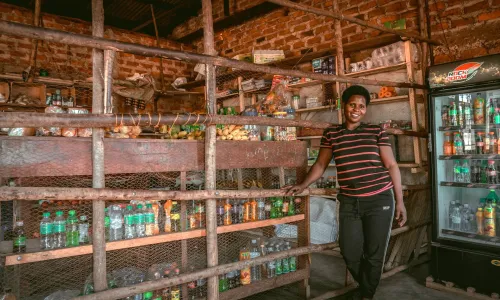 Ugandan woman posing in her confectionary store