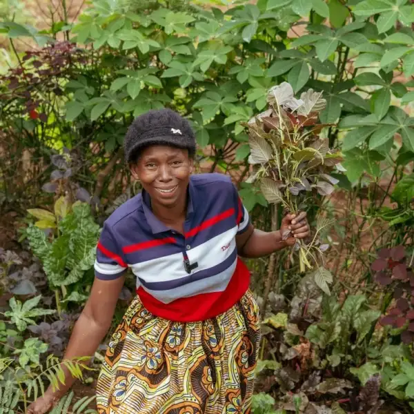 Woman farmer standing in her field with her harvest
