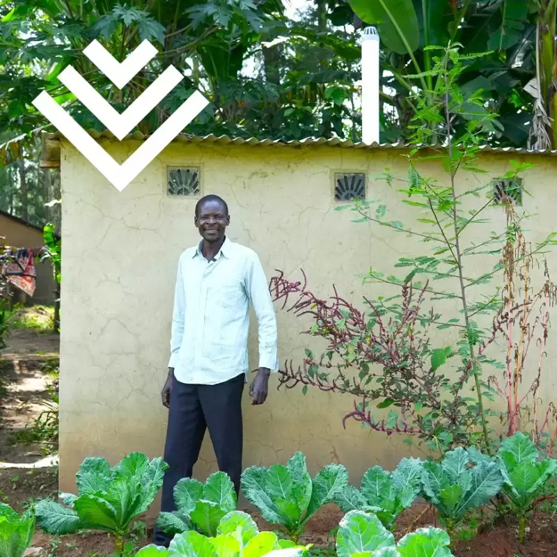 Ripple Effect farmer standing outside his clean latrine