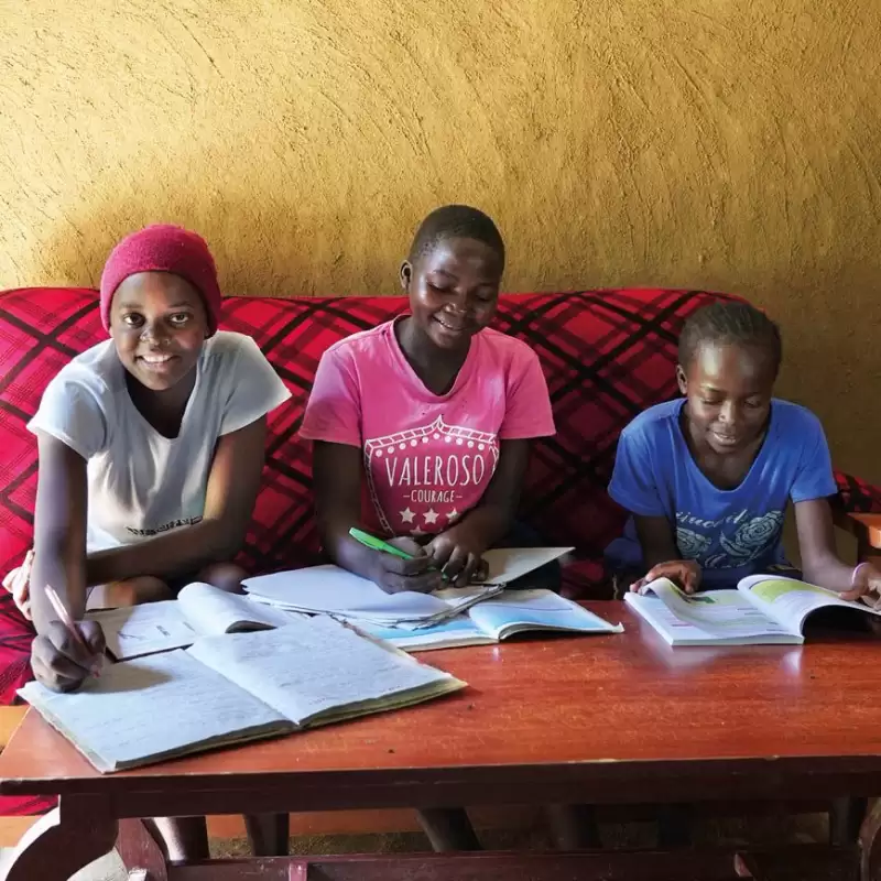 Three children doing their homework