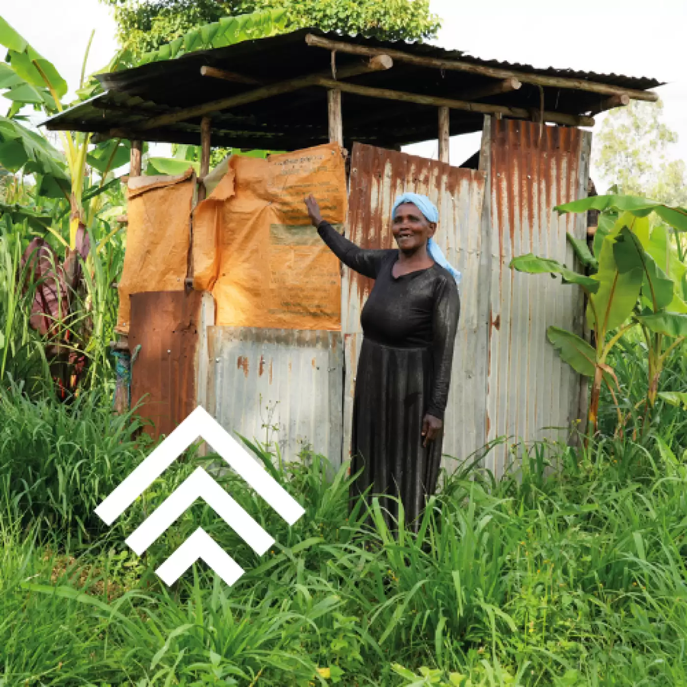 Ripple Effect farmer standing outside her latrine